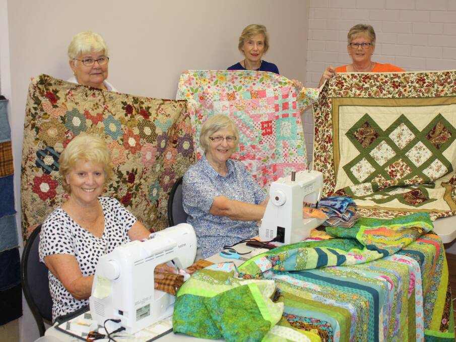 Patchworkers: Cherrhyl Drakes, Maxine Bailey, Wendy Harvey, Kerry Wakely and Lorraine Martin prepare for the upcoming Manning Valley Quilt Exhibition.