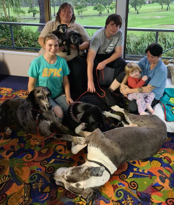 Reunited: Ruth Sumpner (sitting, holding two dogs), with Drew Sumpner-Johnston, Griffon Sumpner-Johnston, Nichole Scott and her two-year-old daughter Alexis Scott.