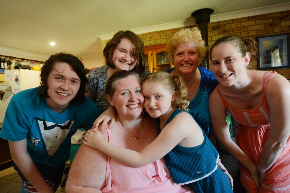 Family: Becci McMullen hugs her mum Nicole and is surrounded by her brother Christian, sister Belinda, grandmother Leonie Storey and her Aunty Allana  Dyscordia. Her younger brother Xavier was not home at the time of the photo. Photo by Scott Calvin.
