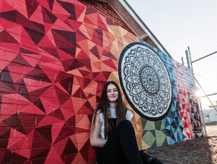 Striking design: Chloe Hargreaves went out of her comfort zone to create the colourful and intricate mural at the Manning Regional Art Gallery. Photo: Jake Davey.