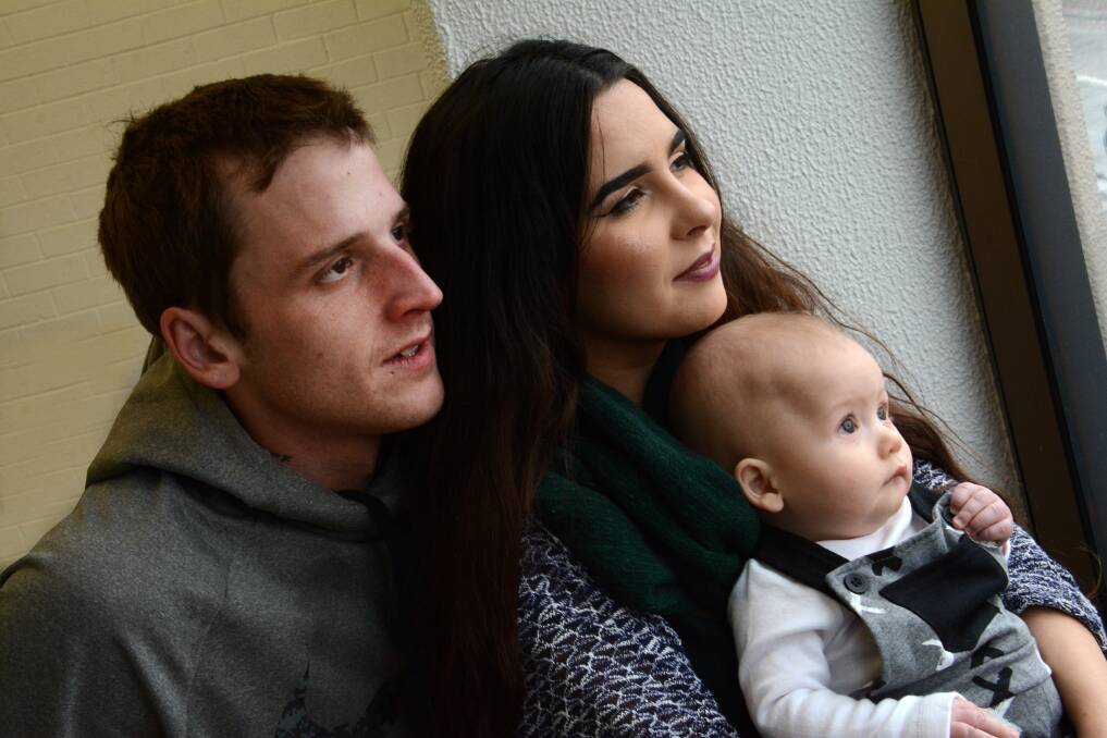 Raising awareness: Aaron Minett and Brittany Cassar with their baby boy, Jasper, who spent a number of days in Manning Hospital fighting a dangerous virus. Photo: Scott Calvin.