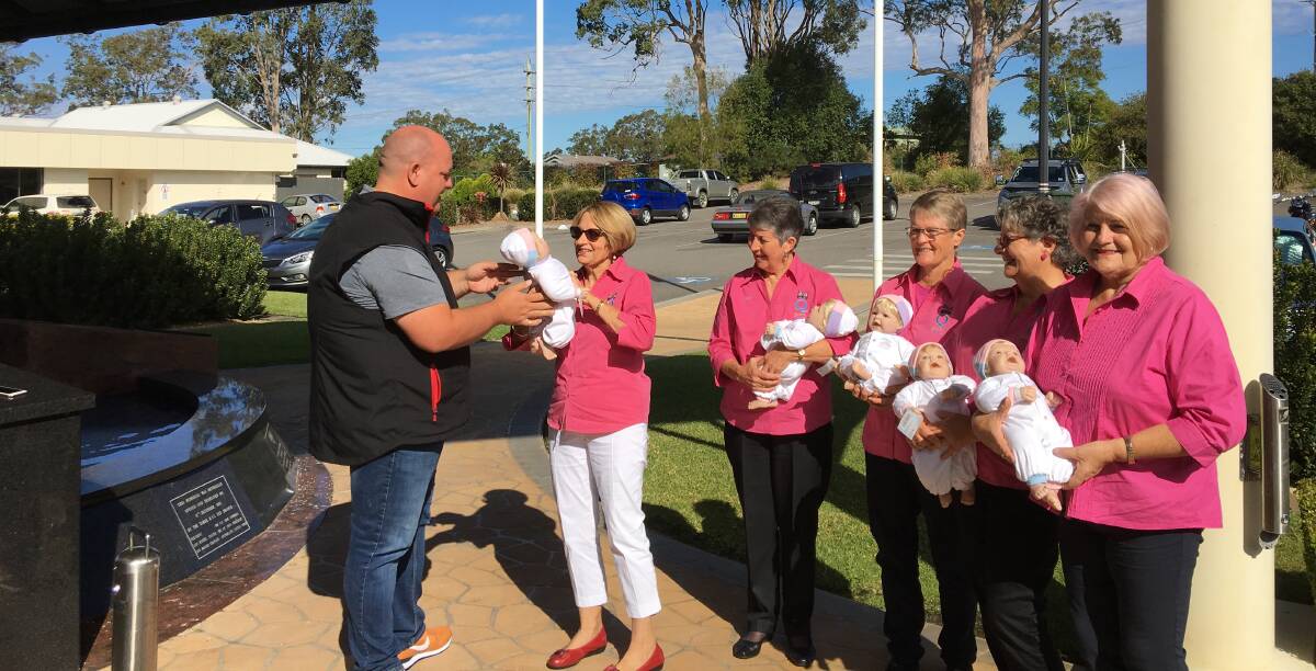 Doll delivery: Club Taree's brand and commusications manager Paul Allan presents the therapy dolls to Taree Quota Club president Nancy Boyling and members Dawn Beer, Marj Phillips, Trish Webber and Lyn Jones.