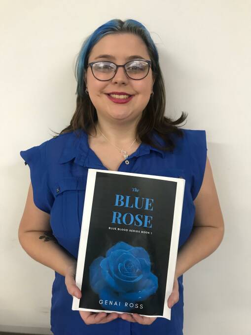 Published: Tayla Ross, who writes under the name Genai Ross, with a copy of her book, The Blue Rose.