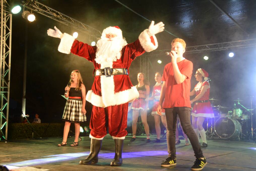Christmas: Santa says hello to the crowd at the 2016 Carols in the Park in Taree. Cassidy Donovan, Conner Langley and back-up dancers perform.