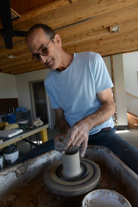 Steve Williams gets to work on his pottery wheel.