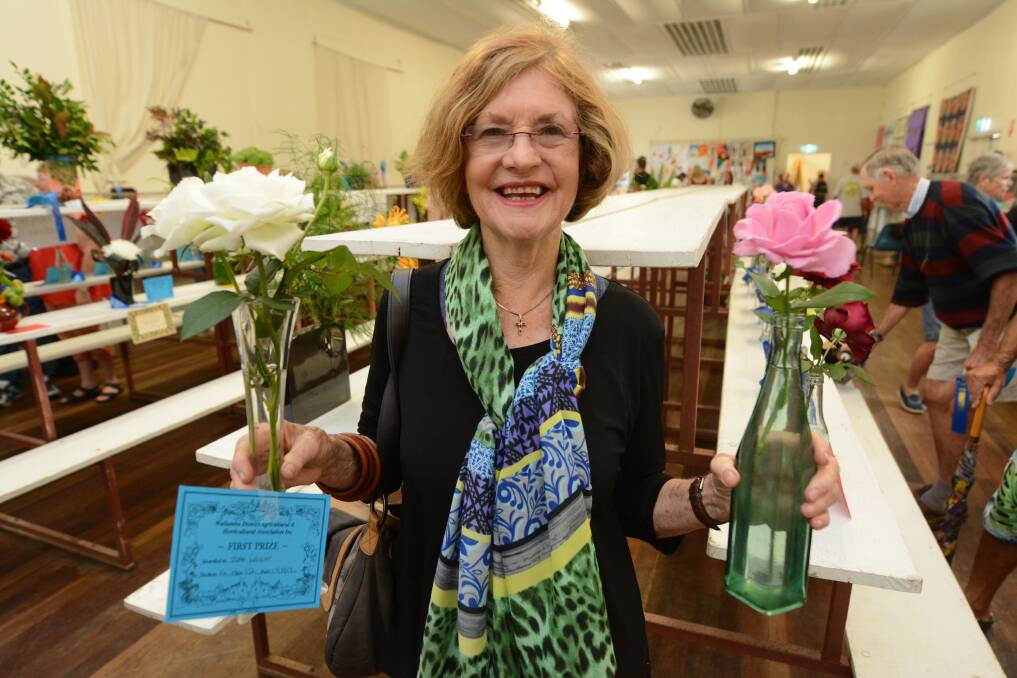 Something for everyone: Jeanie Wright with her champion white rose and first prize pink rose at the 2017 Nabiac Show. Photo: Scott Calvin.