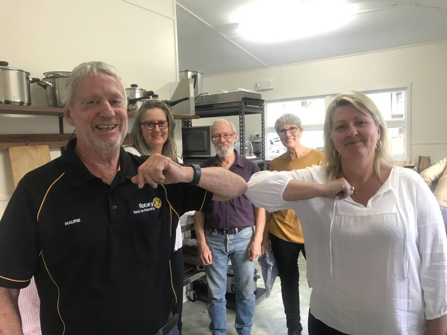 Support: Maurie Stack from the Rotary Club of Taree on Manning "shaking hands" with Sandra Zielke at the Bobin Community Hall, with Tracey Davis, Peter Shouten and Vicki McDonald in the background.