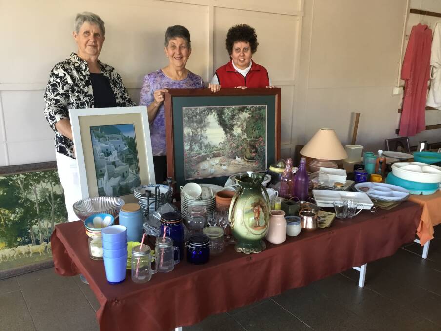 Quotarians: Sue Lucas, Dawn Beer and Romany Low with some of the items for sale at the garage sale.