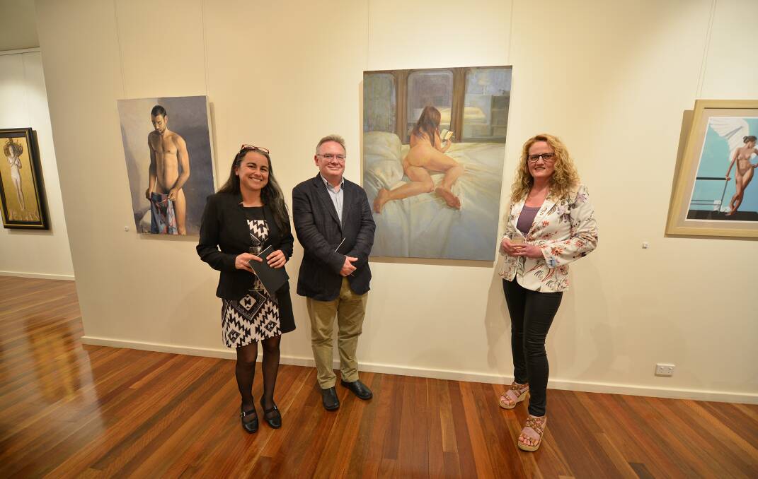 Acting director of Manning Regional Art Gallery Rachel Piercy, judge John McDonald and assistant gallery director Jane Hosking with the winning work by artist Dagmar Cyrulla, 'On the phone IV'. Photo: Julie Slavin.