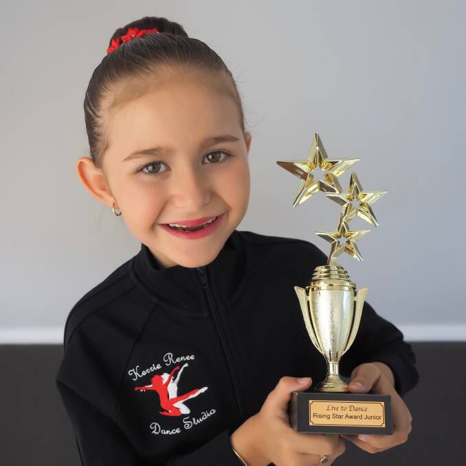 Dancer: Ava Gilbert with the junior Rising Star Award trophy she received at Live to Dance in Forster.