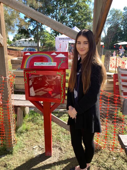 Chloe Hargreaves volunteered her time to paint the street library, which is located at the Taree Community Garden. Photo: Supplied.