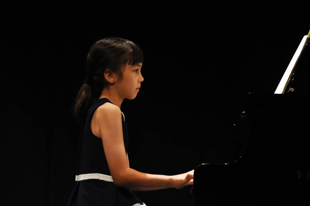 On stage: LinZhao LimSchneider won the Piano Solo 8 years and under section and received the 8 years and under aggregate point score award.