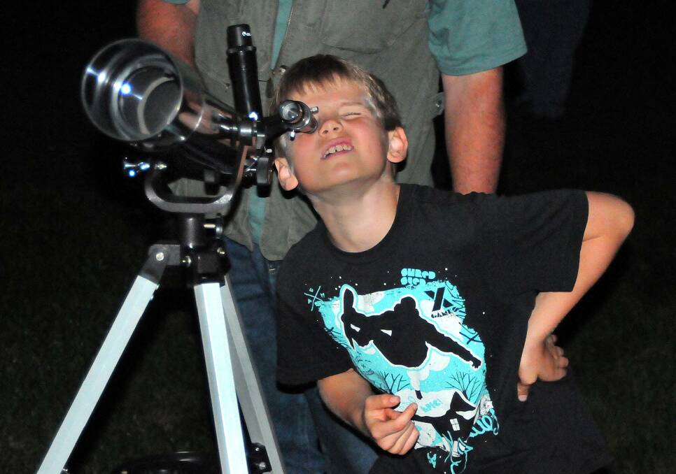 Stargazing for all ages: A young boy looks to the sky through a telescope. Photo: Dave Reneke.
