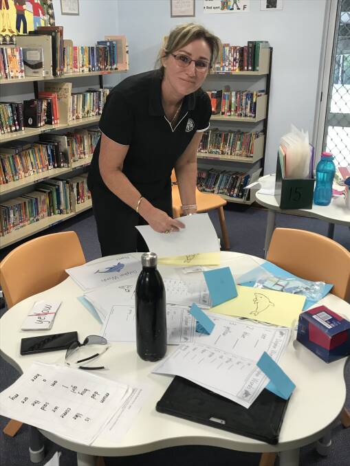 Schooling continues: Learning support officer Mel Bingham makes up work packs for the students of Mitchells Island Public School.