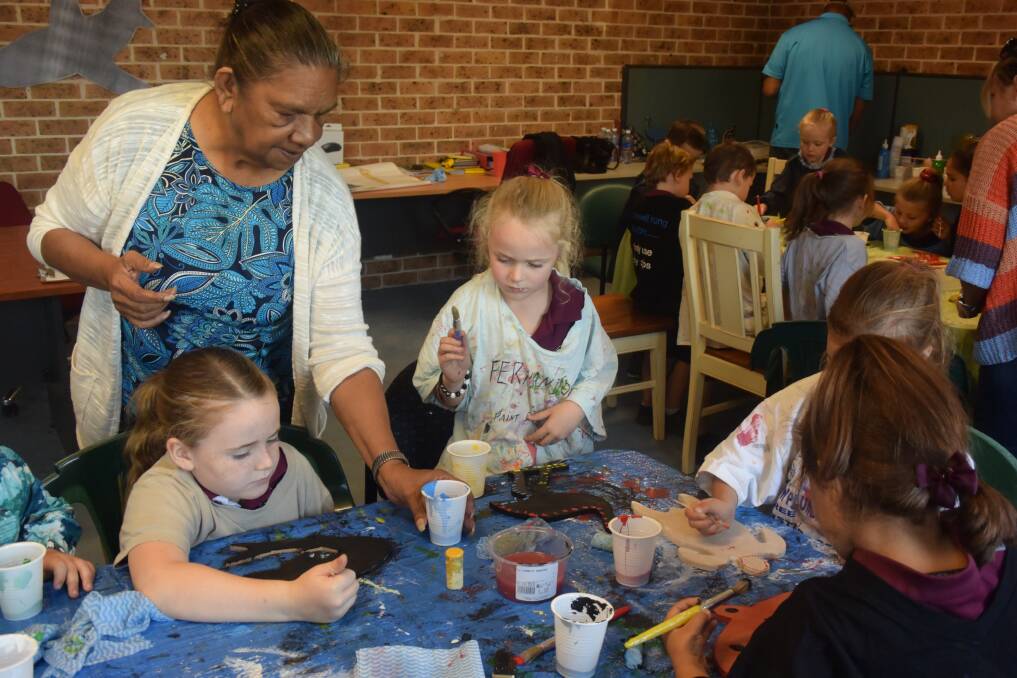 Creative learning: Aunty Fay Ridgeway assists Addison Cross and Lily George from Taree West Public School. Photo: Lauren Green. 