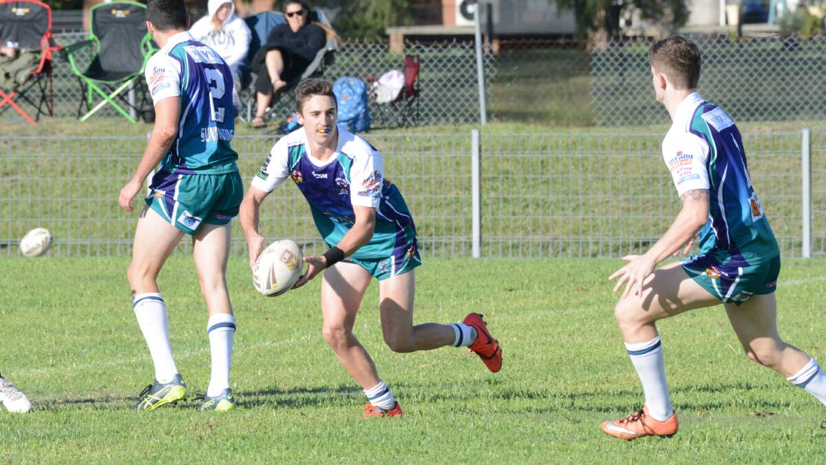 Taree City halfback Dean Mills about to send out a pass during the clash against Forster-Tuncurry at the Jack Neal Oval. The Bulls won 32-16.