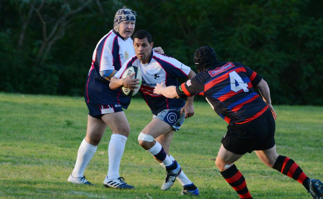 Elusive Manning Ratz fullback Clint Walker looks to evade a Barbarian defender during the clash at Taree Rugby Park.