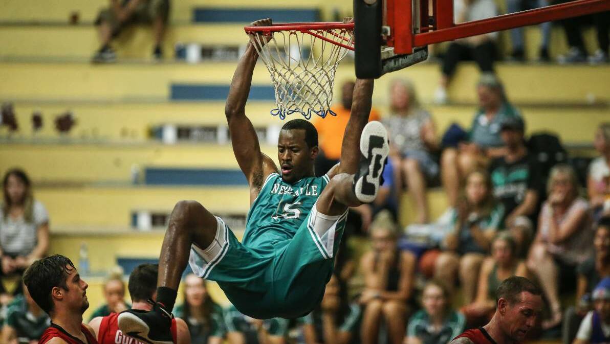 Lonnie Funderburke dunks the ball playing for Newcastle Hunters in the Waratah League. Photo Newcastle Herald/Marina Neil.