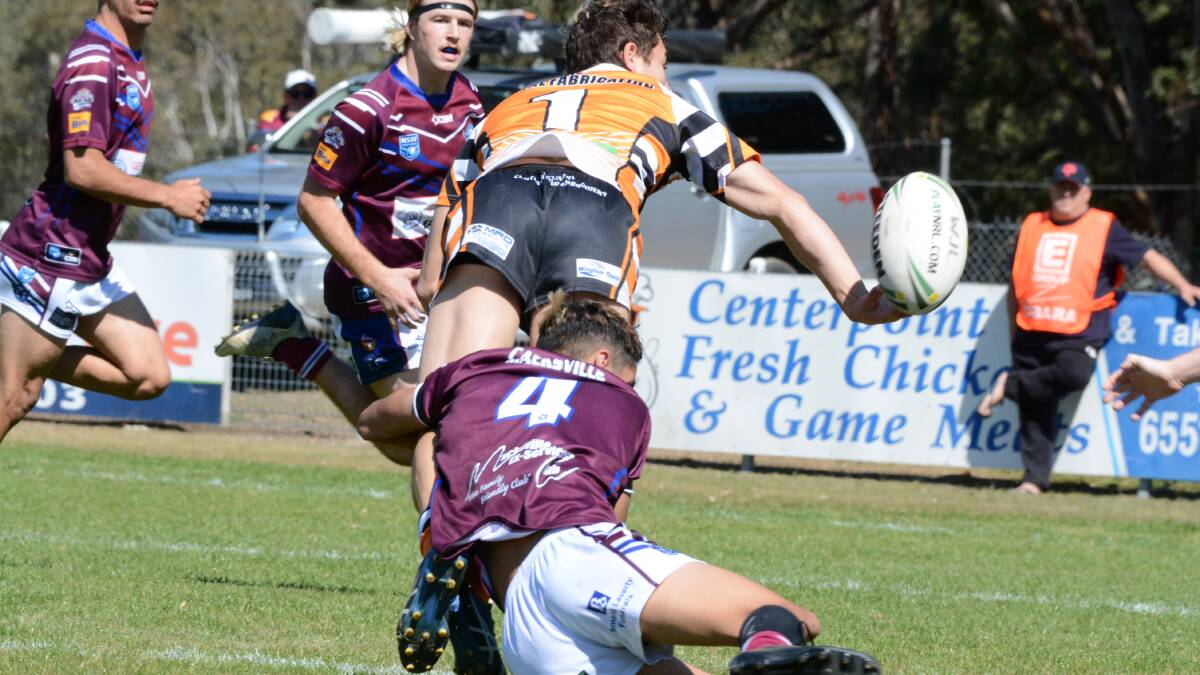 Wingham fullback JJ Gibson flicks a pass to supports during the August 29 clash against Macksville. The Tigers meet Macleay in the under 18 elimination semi-final on Sunday.