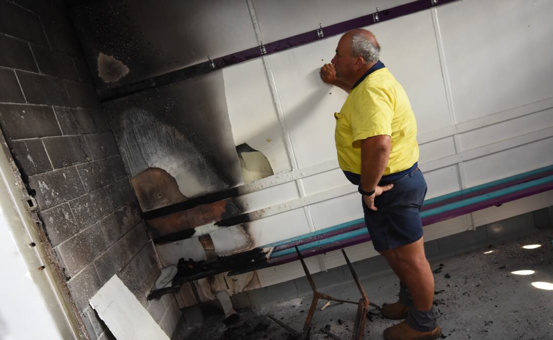 Taree City president Michael Clarke inspects the fire damaged dressing shed.