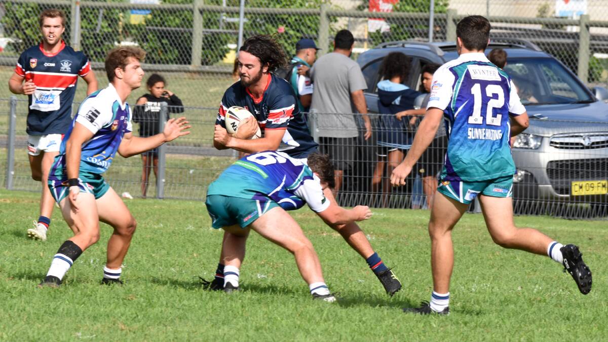 Old Bar fullback Joel Minihan tries to break a tackle in the first round clash against Taree City/