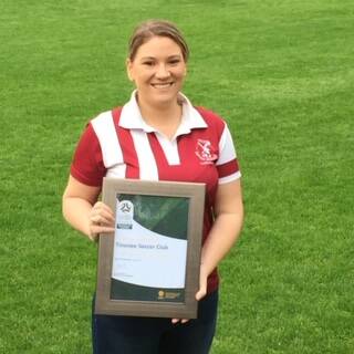 Tinonee Soccer Club secretary Kascie King with the certificate recognising the club's 5 star rating from Northern NSW Football. 