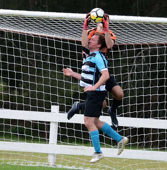 Curtis Jones flies high to make a save for Taree last year. He'll lineup for Port Saints against the Wildcats tomorrow.