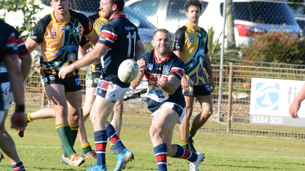 Mick Henry fires out a pass during the match against Forster-Tuncurry
