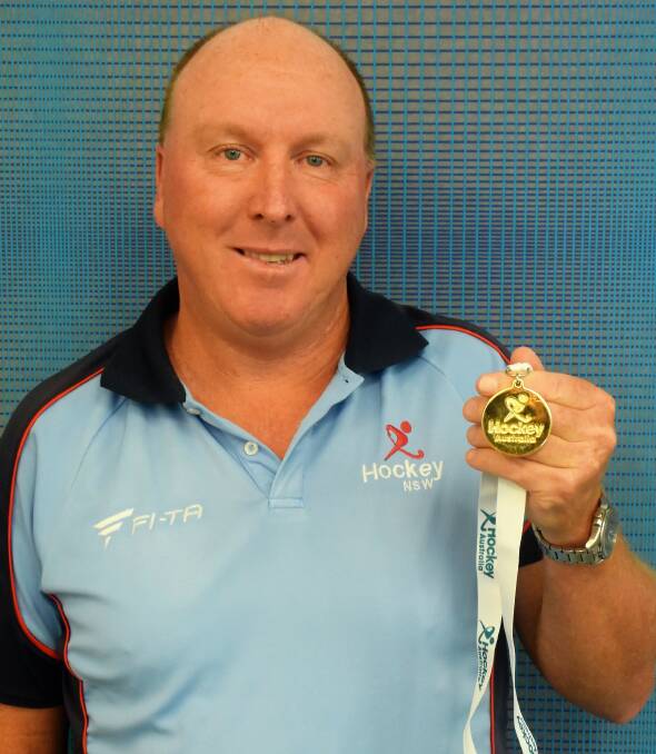 Tony Lewis with the gold medal he won as coach of the NSW women's 50s team at the recent Australian Masters championships on the Gold Coast.