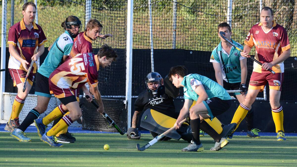 Chatham and Sharks players scramble for the ball during last year's Manning first grade hockey grand final. Both clubs will play in the Mid North Coast Hockey League this year.