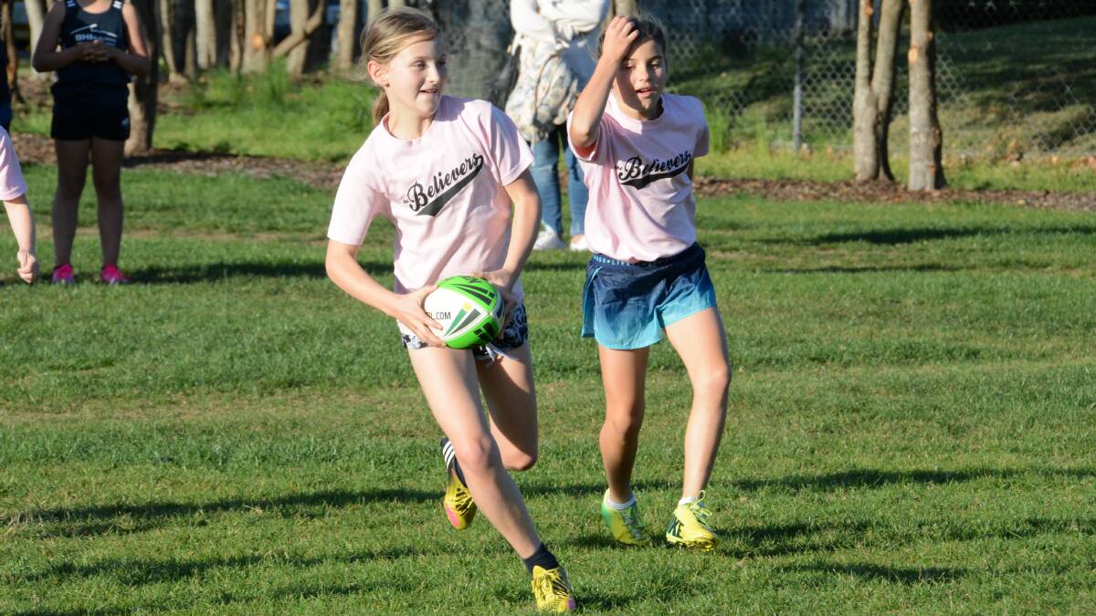 Issy Stevens makes a break during a junior touch football game at Taree last season.