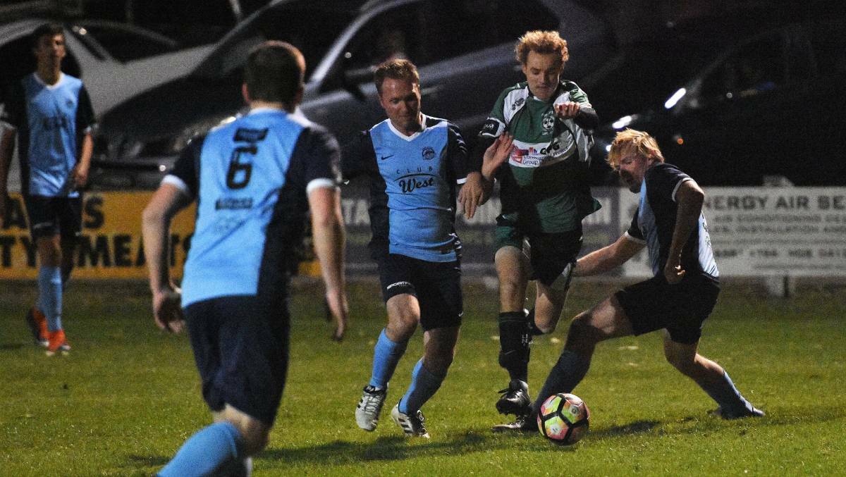 Taree's Justin Atkins attempts to block Port United's Harry Gordon during the Tuesday night clash. Gordon scored three goals in the 7-0 thrashing of the Wildcats. Photo Port News