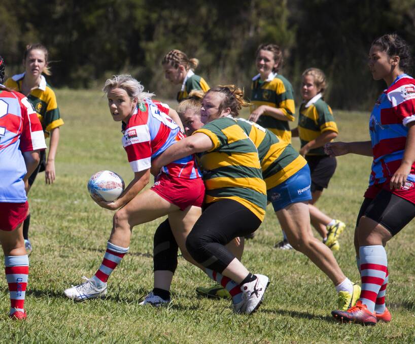 Annie Taylor looks to offload in traffic playing for the Old Bar Clams this season. She's in the Mid North Coast team for this weekend's Country Championships.