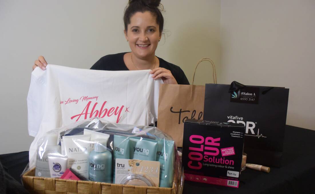 Royal Hotel night club manager, Tahlara Osborne with some of the items donated items for Saturday night's fundraiser.