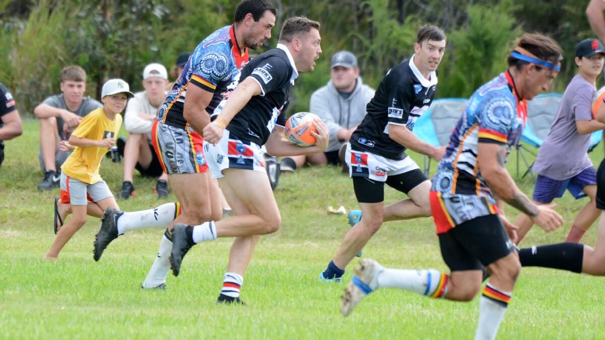 Old Bar's Kurt Lewis makes a break in a trial game against Byron Bay played at the Trad Field at Old Bar in March.