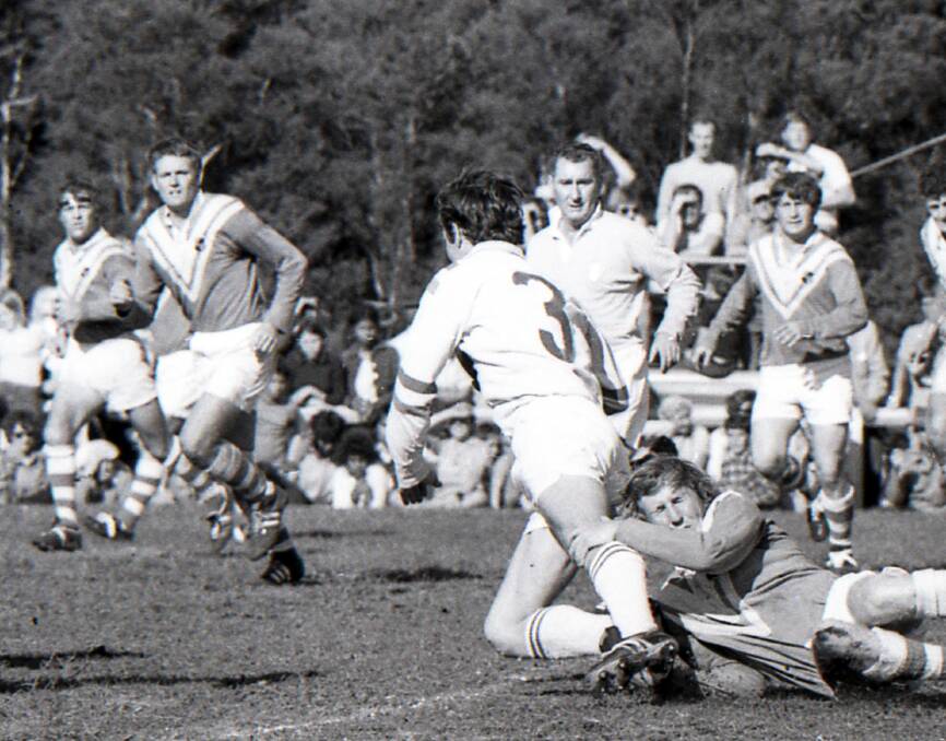 John Adamson is tackles by Taree United's Harold Henry during the 1971 Group Three grand final. Adamson will be inducted into the Group Three Hall of Fame on November 29.