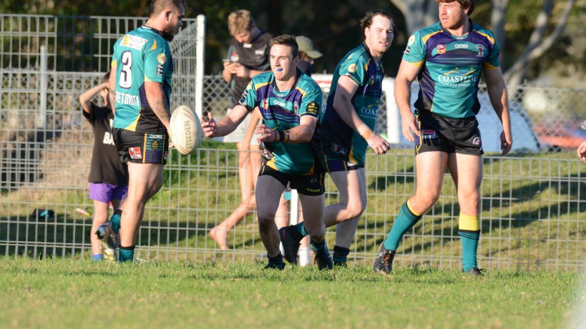 Taree City's Dean Mills fires out a pass during the clash against Wauchope.