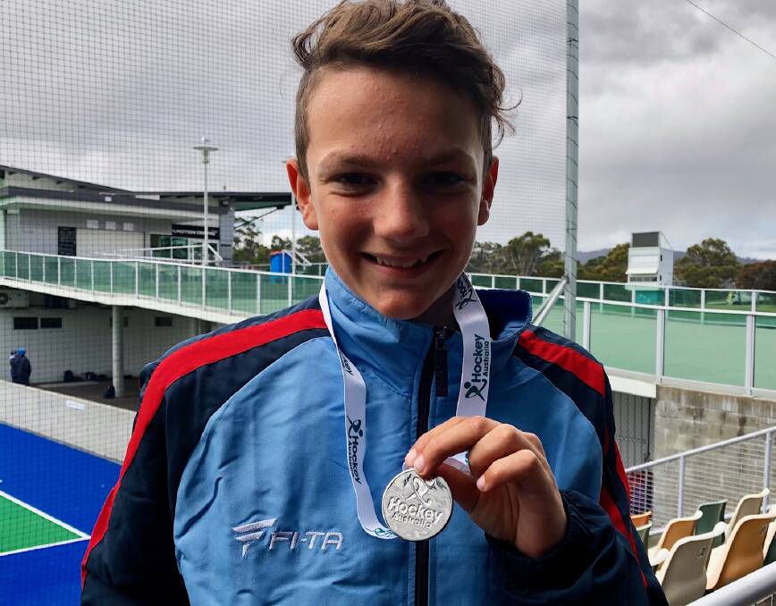 Jayden Manusu with the silver medal he won at the Australian under 13 hockey carnival in Hobart.