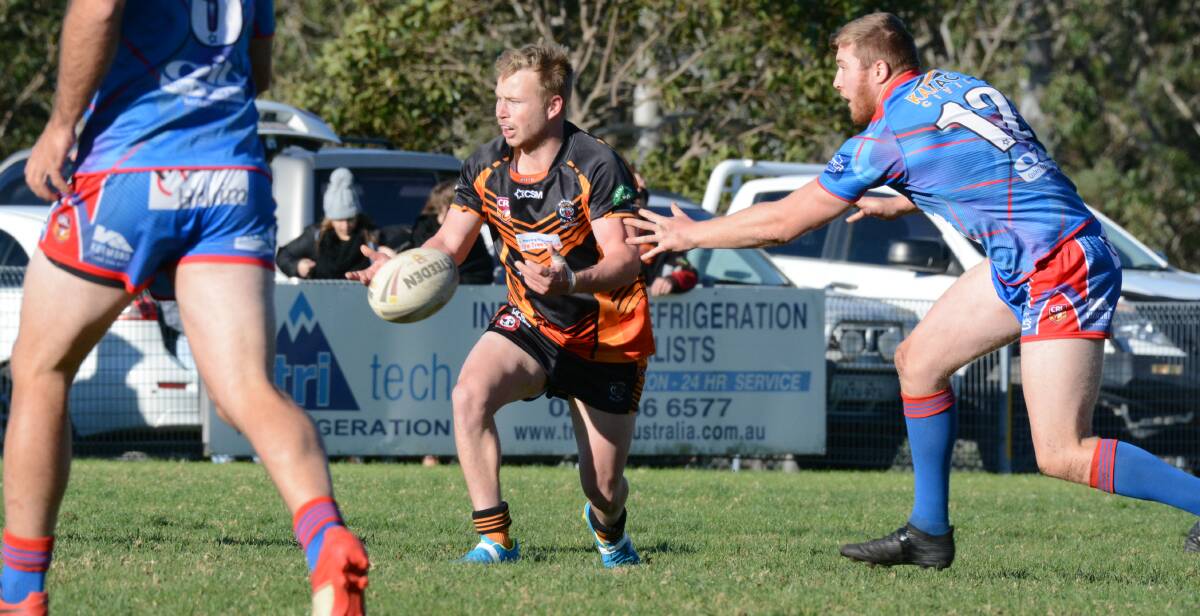 Wingham hooker Mitch Collins fires out a pass during the recent clash against Wauchope. The Tigers meet Old Bar at Wingham on Saturday.