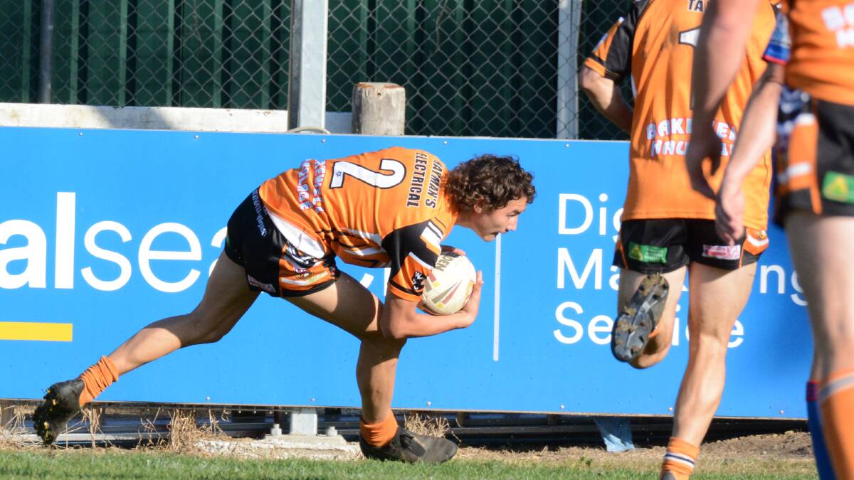 Try time: Wingham winger Jarrad Gibson scores the second of his two tries against the Blues. This gave Wingham an early 10-0 lead.