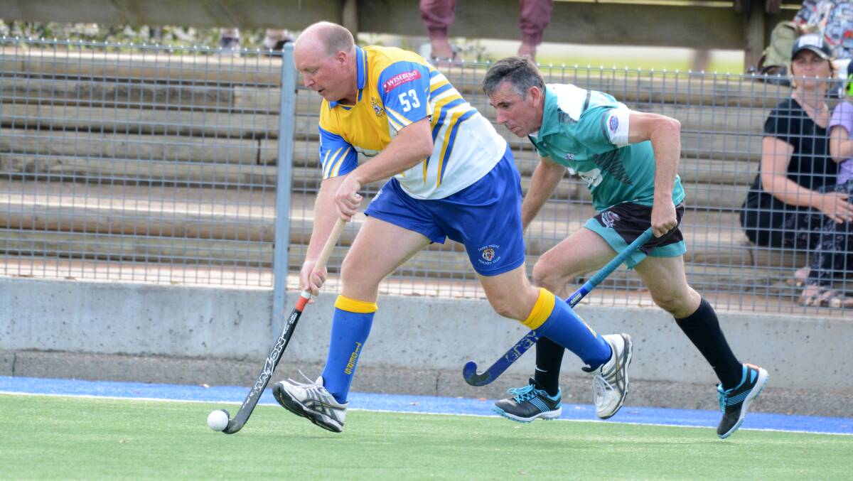 Tony Lewis goes on the attack for Tigers in the Manning men's B-grade grand final this year. He'll be coaching the Australian over 55 women's hockey team at next year's World Cup.
