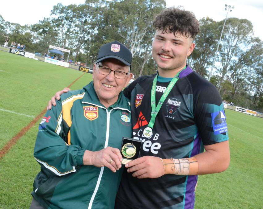Kevin Hardy OAM presents Ethan Ferguson with the under 16 grand final player of the match award now named in his honour.
