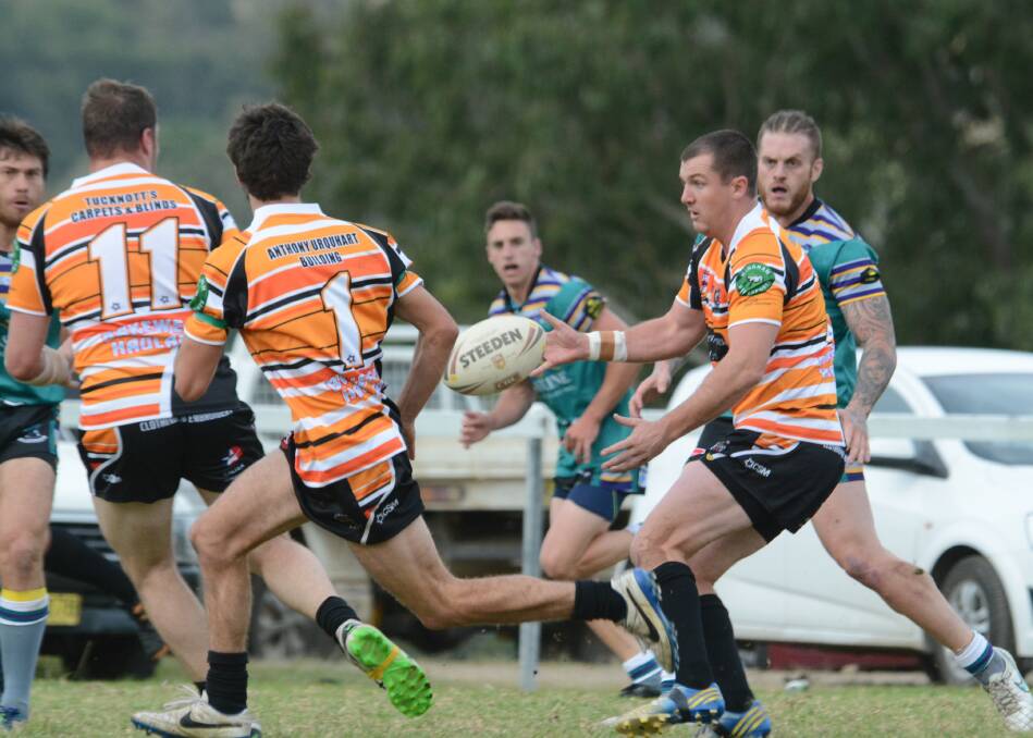 Wingham halfback Trent Green offloads during the match against Taree City at Wingham. Taree City won 28-18.