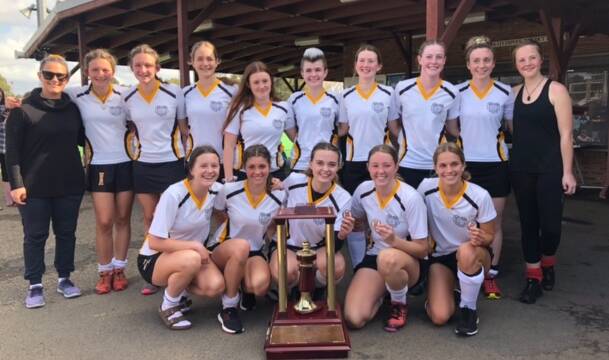 Taree High School's State champion girl's hockey team and the trophy after the 2-1 win over Westfield Sports High.