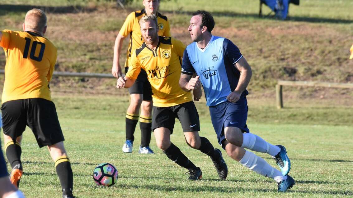 Ricky Campbell from Taree takes on the Tuncurry-Forster defence during a match in the Football Mid North Coast Premier League in 2018. FMNC hopes both clubs will eventually play in the Zone Premier League.