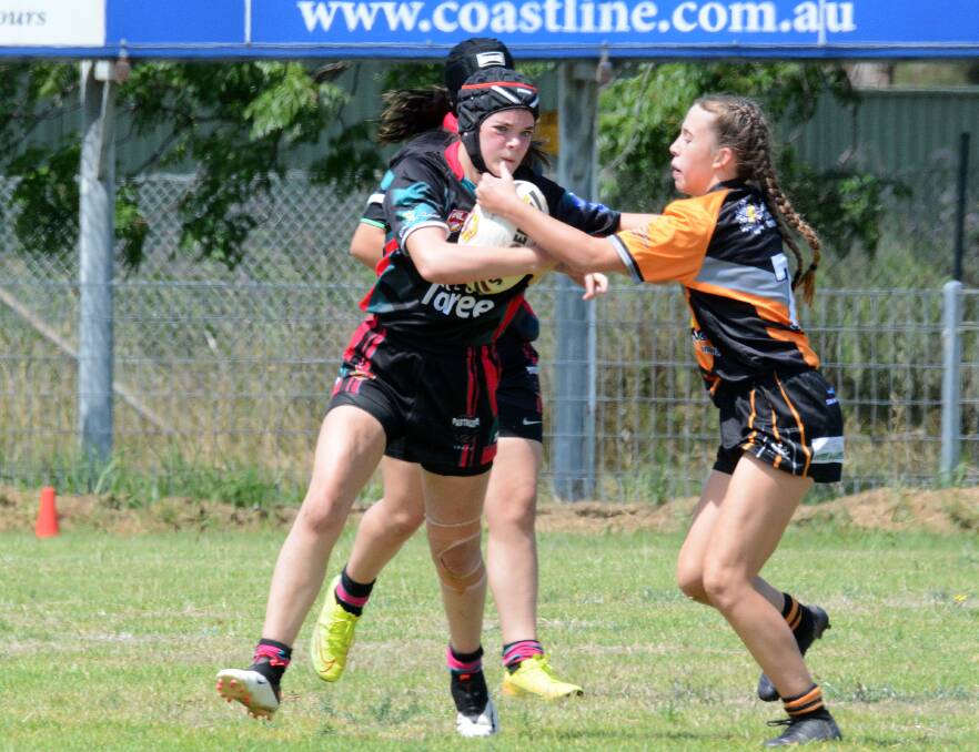 Kedilee Fletcher from Taree Panthers attempts to break a tackle during the North Coast women's 11-a-side rugby league round played in Taree in November.