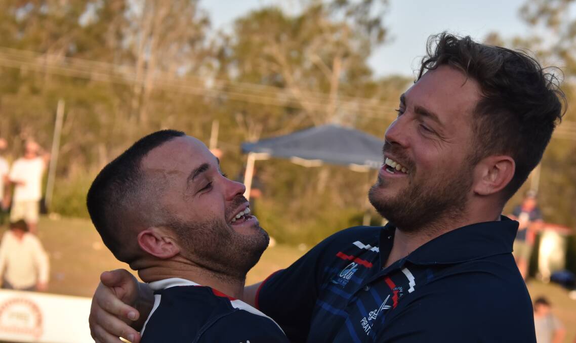 Old Bar co-captain-coach Mick Henry is congratulated by Kurt Lewis after the grand final win. Photo Mardi Borg