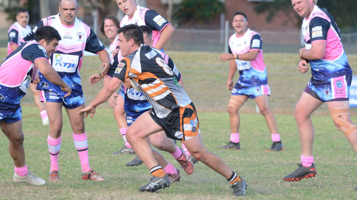 Player of the match, Wingham prop Aaron Groom carts the ball up against Taree City.