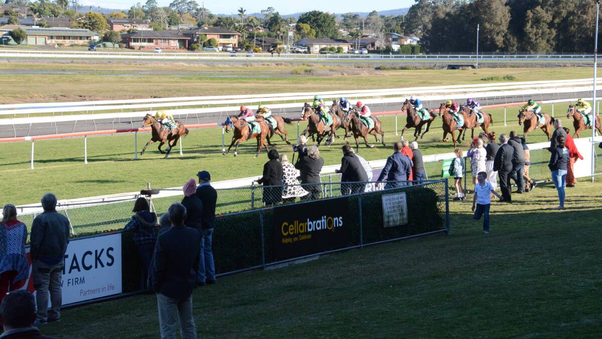 Spectators look on during a race on Taree Cup day on August 23. Crowd numbers were capped at 500 due to COVID-19 protocols.