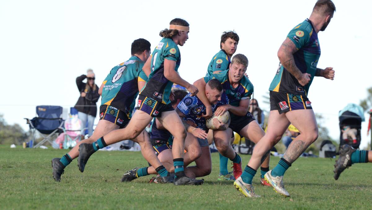 Taree City defenders wrap up an Old Bar ball carrier in the clash at Old Bar. The Bulls meet Wauchope at Taree tomorrow.